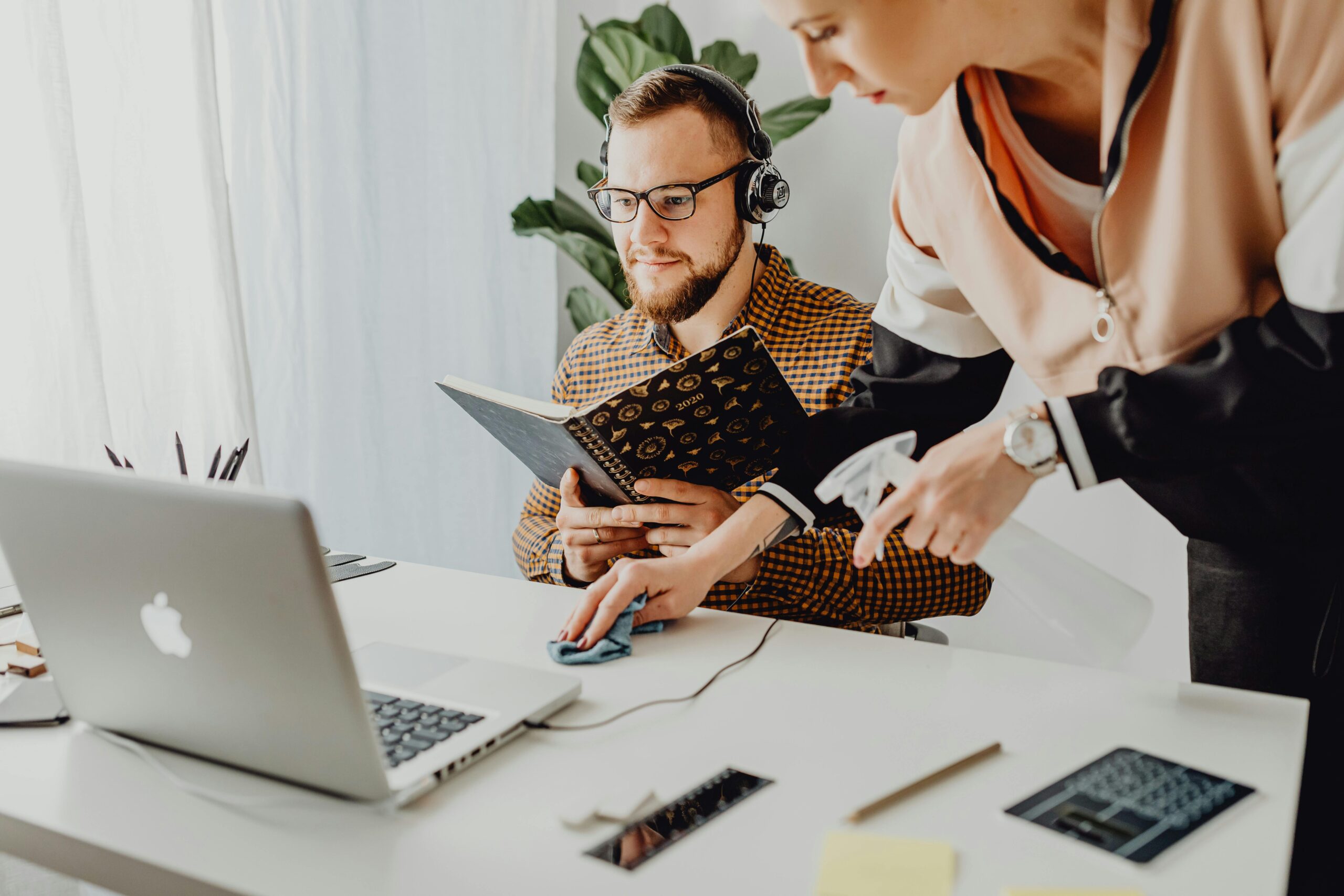A man and woman working together at a desk, enhancing productivity.